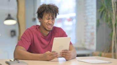 Shocked Young African Man Reacting to Loss on Digital Tablet