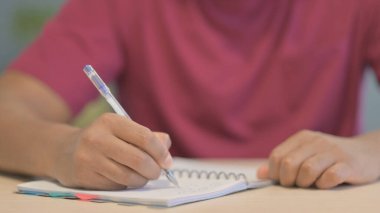 Close up of Male Hand Writing on Paper in Office