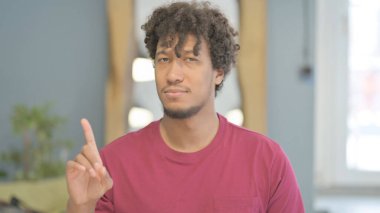 Portrait of Young African Man Showing No Sign with Finger