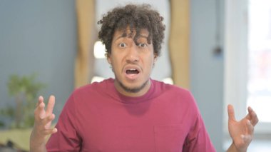 Shocked Young African Man Wondering in Awe, Astonished