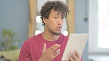 Young African Man Doing Online Video Chat on Tablet