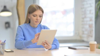 Young Woman using Digital Tablet, Browsing Internet