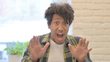 Shocked Young African Man Wondering in Awe, Astonished