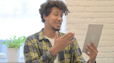 Young African Man Doing Online Video Chat on Tablet