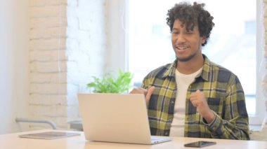 Online Video Chat on Laptop by Young African Man in Office