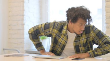 Young African Man Leaving Office after Closing Laptop