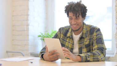 Young African Man Cheering Win on Digital Tablet