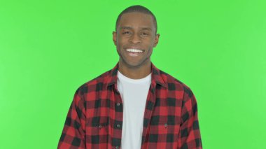 Smiling Young African Man on Green Background