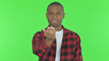 Pointing Young African Man Inviting on Green Background