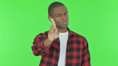 Disliking Young African Man in Denial on Green Background