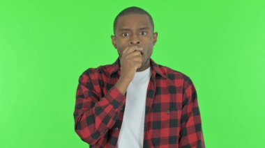 Shocked Young African Man Feeling Surprised on Green Background
