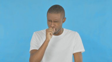 Coughing Young African Man on Blue Background