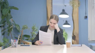 Young Businesswoman Feeling Upset after Reading Documents, Paperwork