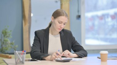 Young Businesswoman Working on Documents, Calculating Business Data