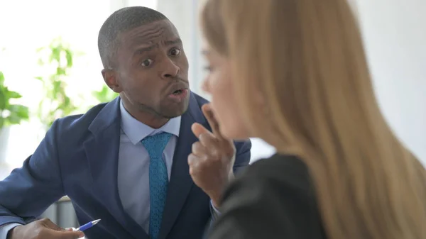 Angry African-American Businessman Talking with Businesswoman, Problems