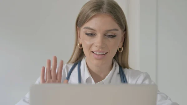 Lady Doctor Talking on Video Call on Laptop in Clinic