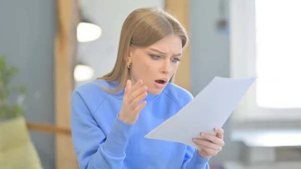 Upset Young Woman Feeling Embarrassed while Reading Contract