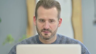 Close Up of Mature Adult Man Celebrating Success on Laptop