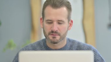 Close Up of Mature Adult Man Reacting to Loss on Laptop
