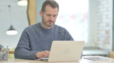 Thumbs Up by Mature Adult Man Working on Laptop