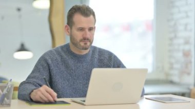 Middle Aged Graphic Designer Working on Laptop and Graphic Tablet