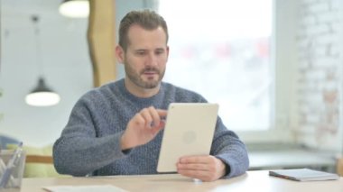Mature Adult Man Cheering Win on Digital Tablet