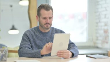 Shocked Mature Adult Man Reacting to Loss on Digital Tablet
