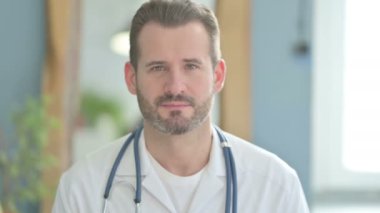 Portrait of Serious Doctor in Clinic