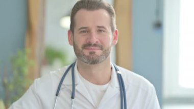 Portrait of Doctor Showing Thumbs Up in Clinic