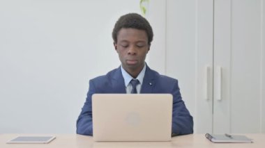 Young African Businessman Typing on Laptop