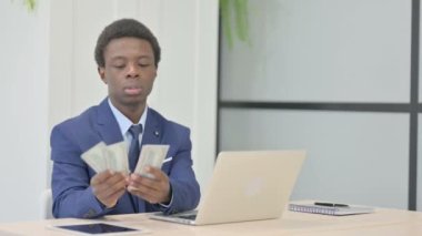 African Businessman Counting Dollar at Work
