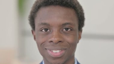 Close Up of Smiling Young African Businessman Face