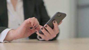 Close up of Old Senior Businesswoman Browsing Internet on Smartphone