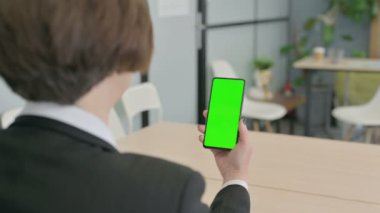 Old Senior Businesswoman using Smartphone with Green Screen