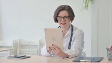 Old Senior Doctor Doing Online Video Chat via Tablet