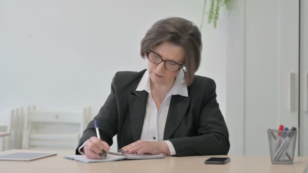 Old Senior Businesswoman Writing While Sitting Office — Video