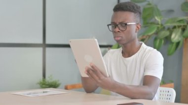 Shocked Young African Man Reacting to Loss on Digital Tablet