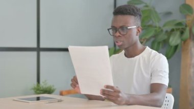 Young African Man Feeling Upset after Reading Documents, Paperwork