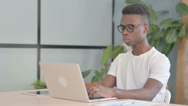 アフリカ系の若者がノートパソコンでタイピング — ストック動画