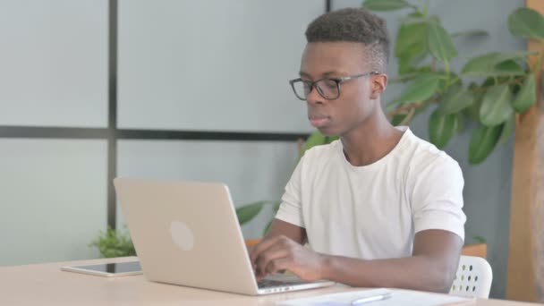 Young African Man Pointing Camera While Working Laptop — Stock Video