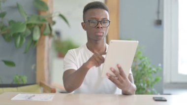 African Man Cheering Win on Digital Tablet