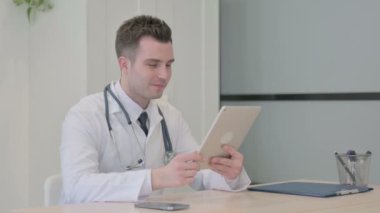 Young Doctor Doing Online Video Chat via Tablet