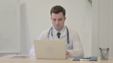 Young Doctor Shaking Head in Rejection in Clinic