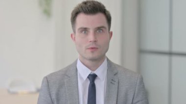 Portrait of Young Businessman shocked by Failure