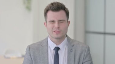 Portrait of Tired Young Businessman with Headache, Migraine