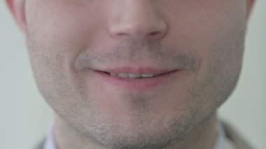 Close Up of Smiling Young Man Lips