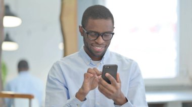 Portrait of African American Man Browsing Smartphone