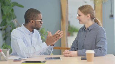 Young African American Man Discussing Work with Partner