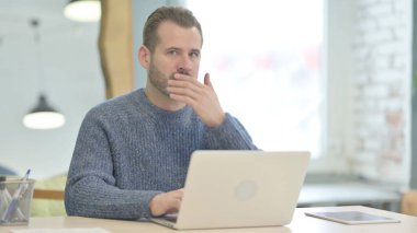 Mature Adult Man Shocked While Working on Laptop