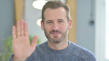 Mature Adult Man Waving Hand to Say Hello